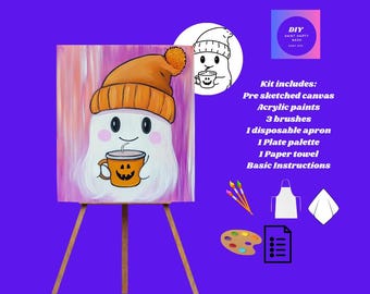 May include: A DIY paint kit featuring a pre-sketched canvas with a cartoon ghost wearing an orange beanie and holding a coffee cup with a jack-o'-lantern face. The kit includes acrylic paints, brushes, an apron, a palette, and instructions.