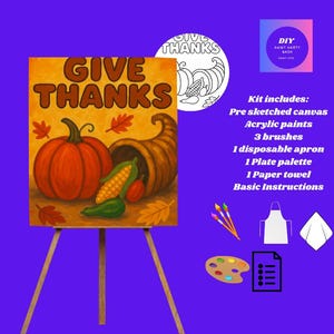 May include: DIY paint kit with a Thanksgiving theme. The canvas shows a pumpkin, cornucopia, and the words "GIVE THANKS." The kit includes a pre-sketched canvas, acrylic paints, brushes, an apron, a palette, a paper towel, and instructions.