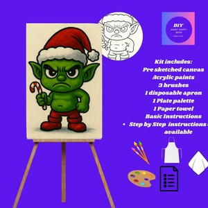 May include: A DIY paint kit featuring a canvas with a pre-sketched cartoon goblin wearing a Santa hat and holding a candy cane. The kit includes acrylic paints, brushes, an apron, a palette, a paper towel, and instructions.