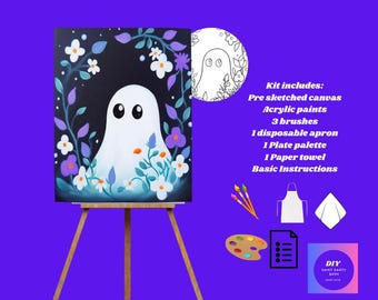 May include: A paint-by-numbers kit featuring a canvas with a ghost design surrounded by flowers. The kit includes acrylic paints, brushes, an apron, a palette, a paper towel, and instructions. The canvas is displayed on a wooden easel.