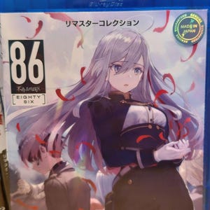 May include: A Blu-ray disc case featuring anime artwork. The cover art showcases a female character with long silver hair and a black uniform. The title "86 EIGHTY-SIX" is prominently displayed, along with Japanese text. A "Made in Japan" sticker is visible.
