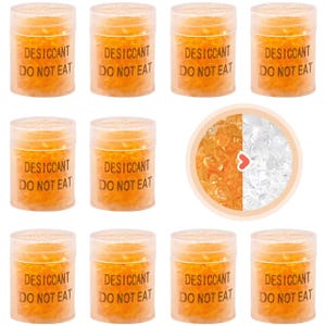 May include: Ten small clear plastic containers filled with orange silica gel beads. The containers have a black label with the text "DESICCANT DO NOT EAT".