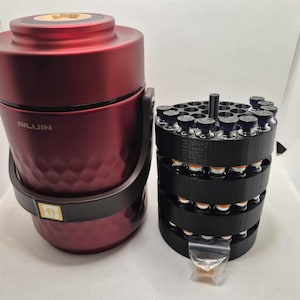May include: A burgundy-colored container with the text "AILUIN" and a black handle next to a black multi-tiered holder filled with small vials. The vials have orange and blue caps. A small plastic bag is at the bottom.