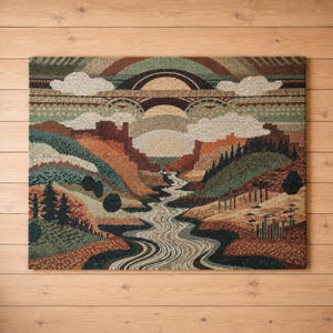 May include: A rectangular wall hanging featuring a woven landscape scene with a central winding river, layered canyon rock formations in shades of rust and brown, evergreen trees, and a stylized sky with arched bands and white clouds.