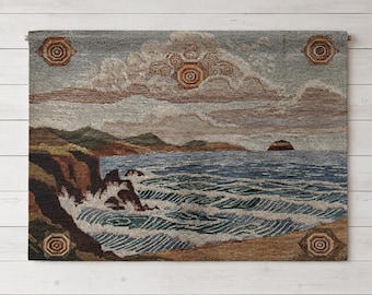 May include: A rectangular woven wall tapestry featuring a coastal landscape with crashing waves against dark cliffs, a distant island, and stylized clouds in the sky. The design includes four decorative octagonal motifs in the corners and center.