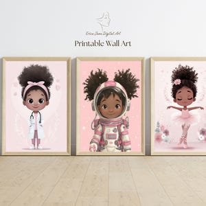 May include: Three framed wall art prints featuring illustrations of young children with dark skin and curly hair. The left print shows a doctor with a stethoscope, the centre shows an astronaut in a pink suit, and the right shows a ballerina.