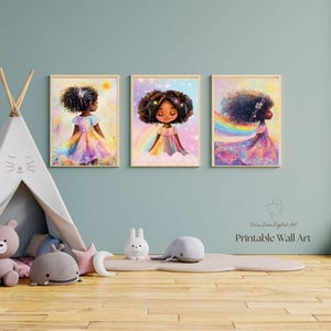 May include: Three framed wall art prints featuring a young girl with dark curly hair in a rainbow-colored dress. The illustrations include elements like rainbows, stars, and soft clouds. The text "Erica Jane Digital Art Printable Wall Art" is visible.