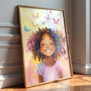 May include: A framed wall art print featuring a smiling person with curly dark hair surrounded by colorful butterflies. The background is a soft watercolor blend of yellow, pink, and blue hues with sparkling light accents. The person wears a light shirt.