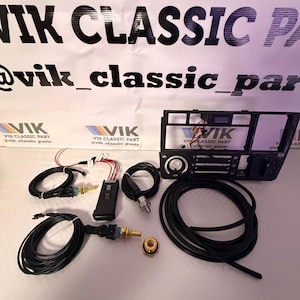 May include: A selection of black automotive components, including wiring looms, a control module, and a dashboard element. The text "VIK CLASSIC PART" and "@vik_classic_parts" is visible.