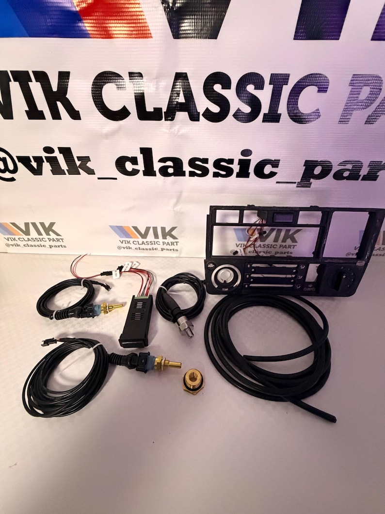 May include: A selection of black automotive components, including wiring looms, a control module, and a dashboard element. The text "VIK CLASSIC PART" and "@vik_classic_parts" is visible.