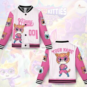 May include: A pink and white baseball-style jacket with a cartoon cat superhero design. The jacket features the name "Ginny" and the number "001" on the front, and "YOUR NAME" on the back. The sleeves are pink with cat face graphics.