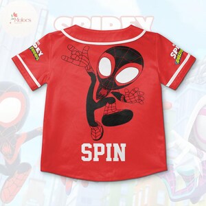 May include: Red baseball jersey with a black and white Spider-Man character graphic. The jersey has white trim and the words "SPIDEY FRIENDS" and "SPIN" on the front.