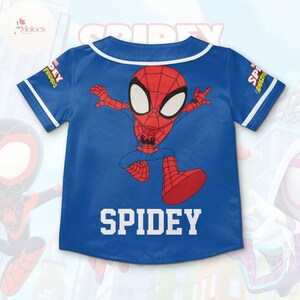 May include: Blue baseball jersey with a cartoon image of Spiderman running. The jersey has white trim and the text "SPIDEY" on the back.