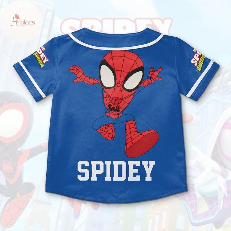 May include: Blue baseball jersey with a cartoon image of Spiderman running. The jersey has white trim and the text "SPIDEY" on the back.