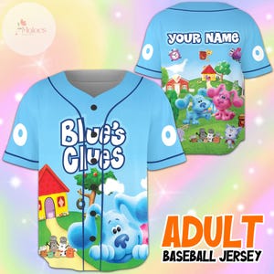 May include: Light blue adult baseball jersey featuring the text "Blue's Clues" on the front. The jersey has a cartoon graphic of Blue and other characters from the show. The back of the jersey has the text "YOUR NAME".