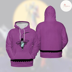 Puede incluir: Sudadera con capucha morada con un personaje de dibujos animados con sombrero de bruja. La parte delantera de la sudadera muestra la cara del personaje, mientras que la parte trasera es lisa. Un ribete negro festoneado acent&uacute;a el dobladillo. Capucha forrada en blanco.