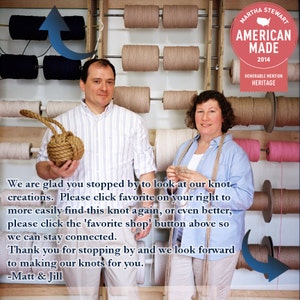May include: Two people stand in front of a wall of spools of twine. The woman on the right is holding a spool of twine and the man on the left is holding a knotted rope ball. The sign above them reads "MARTHA STEWART AMERICAN MADE 2014 HONORABLE MENTION HERITAGE".