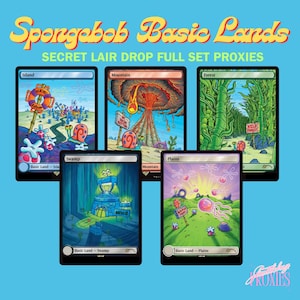 May include: A white ceramic mug with a black handle and the text "But First, Coffee" in a black, handwritten-style font. The mug is on a white surface.