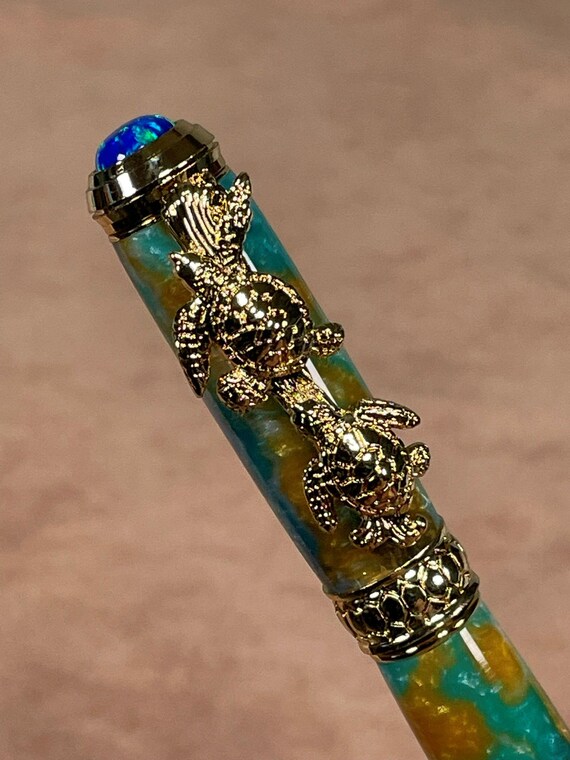 Sea Turtle Rollerball Pen with 24k Gold Trim, featuring a Blue synthetic Fire Opal and intricate Sea Turtle designs Handcrafted Luxury Gift