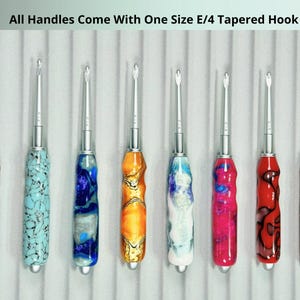 May include: A collection of eight crochet hooks with colorful, patterned handles. The handles feature a variety of colors including orange, blue, red, and brown. The text at the top reads "All Handles Come With One Size E/4 Tapered Hook."