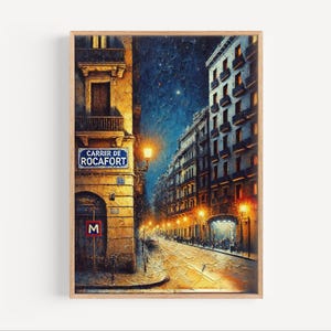 May include: An oil painting of a European street scene at night, framed in a wooden frame. The artwork depicts buildings with lit windows, streetlights, and a street sign that reads "Carrer de Rocafort". The color palette includes blues, yellows, and oranges.