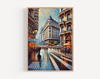 May include: A painting of a city street scene with people walking on a cobblestone street. The street is lined with buildings, and there are trees and streetlights. The painting is in a wooden frame.