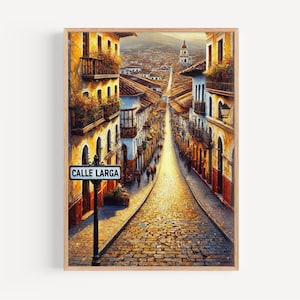 May include: A framed art print of a cobblestone street scene. The artwork depicts a long street lined with buildings in warm tones, with a sign that reads "CALLE LARGA". The buildings have balconies and red tile roofs. The street is filled with people.