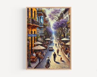 May include: A framed print of a street scene in Guatemala. The artwork depicts a cobblestone street lined with buildings, cafes, and people. The sky is a soft blue, and the trees are in full bloom with purple flowers. A sign reads "Guatemala".