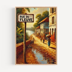 May include: A framed art print of a street scene with a sign that reads "RUE DU FLEUVE". The artwork depicts a cobblestone street with buildings, people, and a river in the background. The color palette is warm, with shades of brown, yellow, and blue.