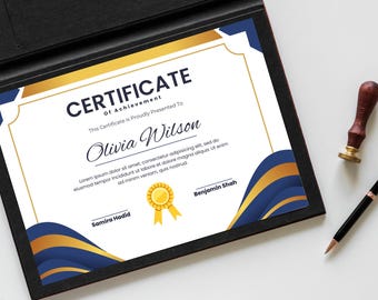 May include: A certificate of achievement in a black frame, with gold and blue decorative elements. The certificate reads "CERTIFICATE Of Achievement" and the name "Olivia Wilson". A pen and a stamp are next to the certificate.