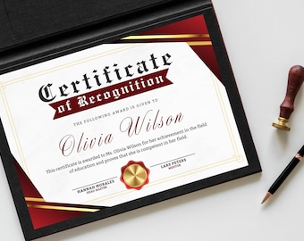 May include: A certificate of recognition in a black folder with gold detailing. The certificate features a red and gold border and the text "Certificate of Recognition" and the name "Olivia Wilson". A pen and a wax seal are placed nearby.