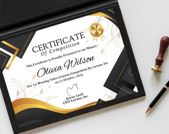 May include: A certificate of competition with gold and black detailing. The certificate reads "Certificate of Competition" and features the name "Olivia Wilson". A gold seal, a pen, and a stamp are also visible.