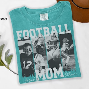 May include: Seafoam green t-shirt with the words "FOOTBALL MOM" in white block letters. The shirt features four black and white images of football players. The names "Josue" and "Ethan" are written in cursive below the word "MOM".