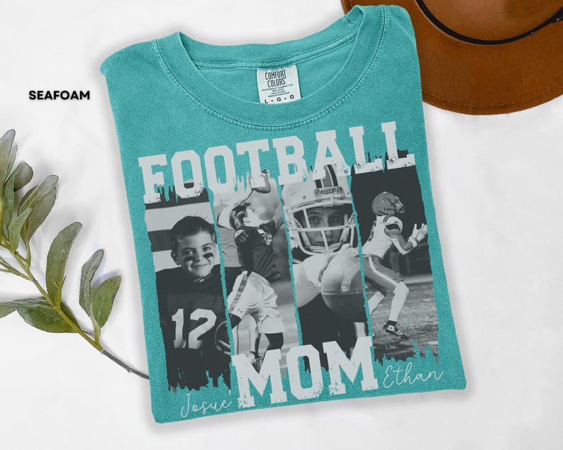 May include: Seafoam green t-shirt with the words "FOOTBALL MOM" in white block letters. The shirt features four black and white images of football players. The names "Josue" and "Ethan" are written in cursive below the word "MOM".