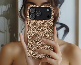 May include: A phone case with a leopard print design. The case is brown and tan with a repeating pattern of spots. The phone case has a black camera module with three lenses and a flash.