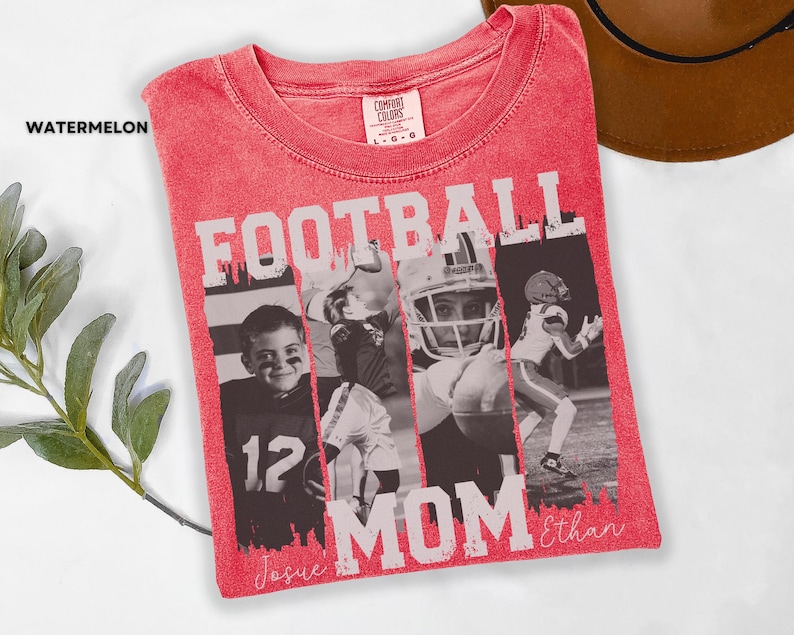 May include: A red t-shirt with the words "FOOTBALL MOM" in white block letters. The shirt features a collage of football players and the names "Josue" and "Ethan" in script. The shirt is labeled "Watermelon".