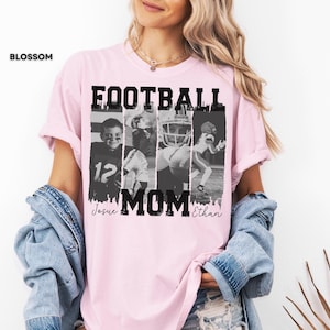 May include: A light pink t-shirt with the word "FOOTBALL MOM" in bold black letters. The shirt features four black and white images of football players. The names "Josue" and "Ethan" are written in cursive below the word "MOM".