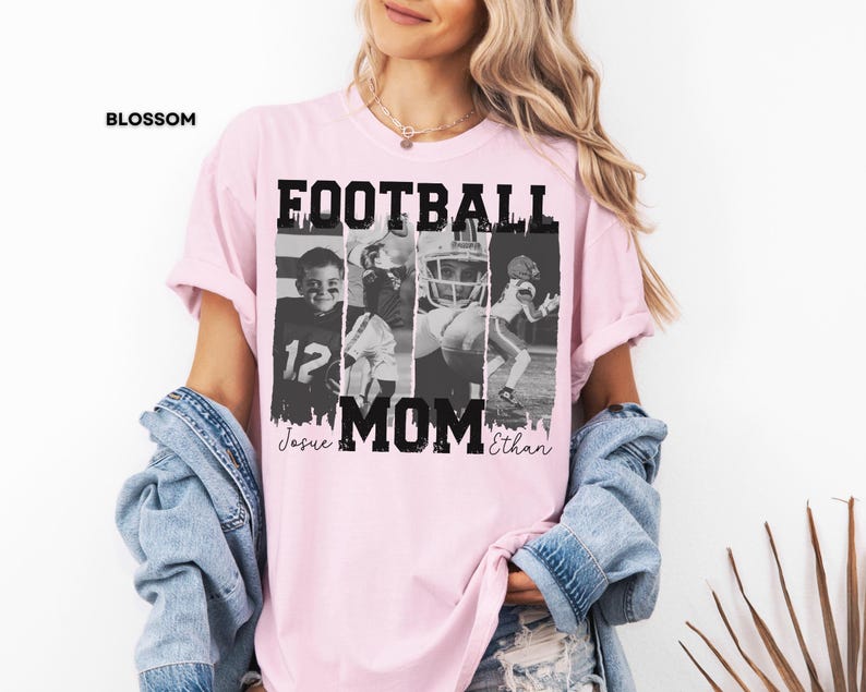 May include: A light pink t-shirt with the word "FOOTBALL MOM" in bold black letters. The shirt features four black and white images of football players. The names "Josue" and "Ethan" are written in cursive below the word "MOM".