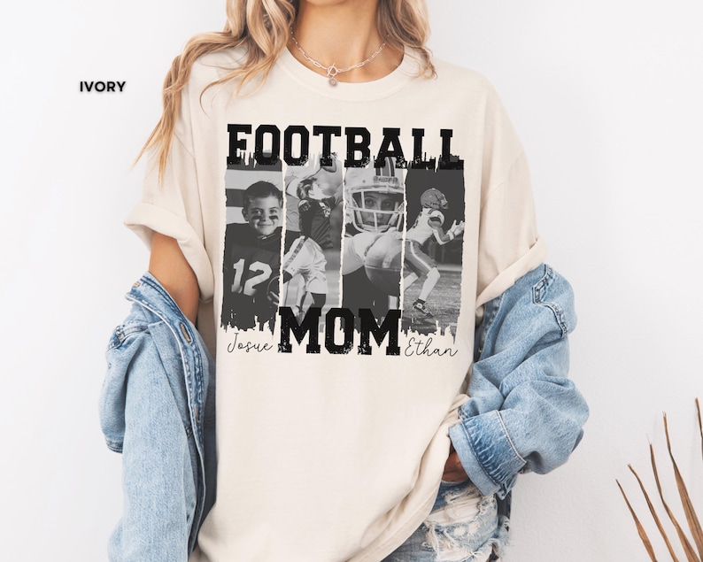 May include: Ivory-colored t-shirt with the text "FOOTBALL MOM" in bold black letters. The shirt features four black and white images of football players. The names "Josue" and "Ethan" are printed below the word "MOM".