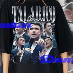May include: Black oversized t-shirt featuring a collage of images and the name "TALARICO James" in a silver, stylized font. The shirt has a crew neck and short sleeves. The background has a blurred effect with lightning bolts.