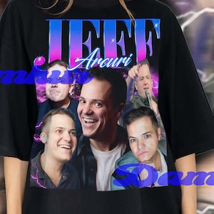 May include: Black oversized t-shirt featuring a graphic of Jeff Arcuri and the text "Jeff Arcuri" in blue and purple. The shirt has a vintage style design with a blurred background.