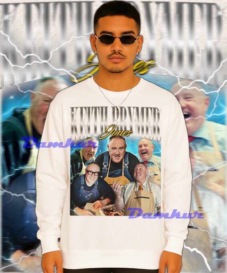 May include: White sweatshirt featuring a graphic of a group of men with the text "Keith Prymer Jones" in a vintage style. The design is set against a blurred background with lightning bolt accents.