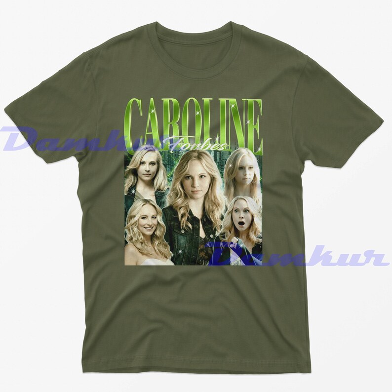 May include: Olive green t-shirt with a graphic of Caroline Forbes, the name in a green, stylized font. The graphic includes multiple images of the actress. A vintage-style design.