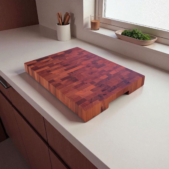 End-grain pear wood produces a naturally deep burgundy tone that looks more like stained hardwood than something that grew on a tree — genuinely rare material choice.