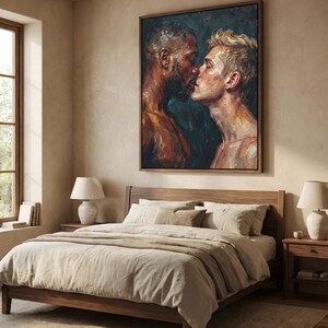 May include: A bedroom scene featuring a large framed painting of two men kissing, above a wooden bed with beige bedding. Two matching bedside tables with lamps flank the bed. The room has a neutral color palette with natural light.