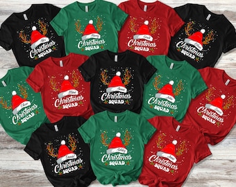 May include: A collection of Christmas Squad t-shirts in various colors, including black, green, and red. Each shirt features a Santa hat design with a name and the words "Christmas Squad".