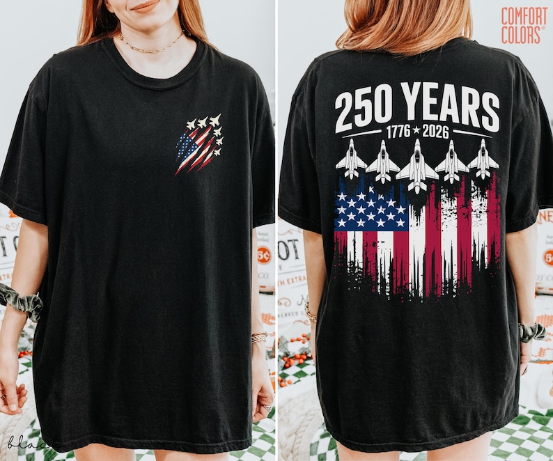 May include: A black short-sleeve t-shirt featuring a small graphic on the front left chest of a distressed American flag with fighter jets. The back displays the text 250 YEARS 1776-2026 above five fighter jets and a large distressed American flag.