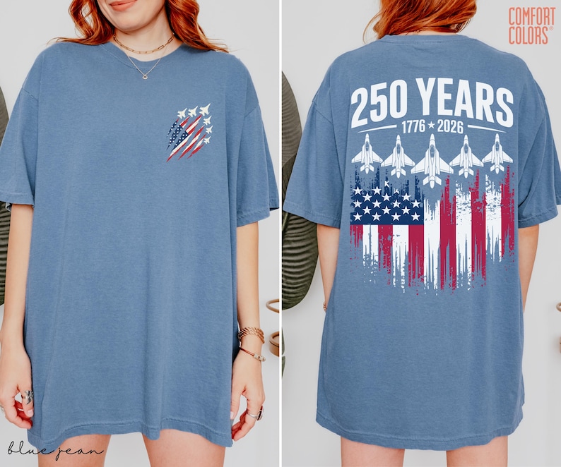 May include: A blue short-sleeve t-shirt featuring a small graphic on the front left chest of fighter jets and a flag. The back displays the text 250 YEARS 1776-2026 above five fighter jets and a distressed American flag graphic design.