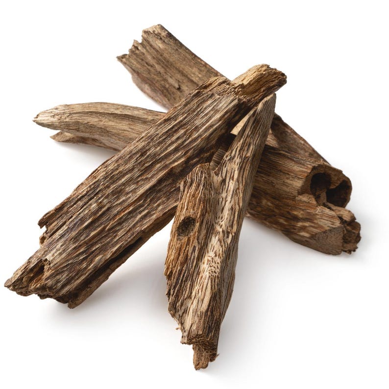May include: Three pieces of brown wood, probably from a tree, with a rough, textured surface. The wood is arranged in a triangular shape.