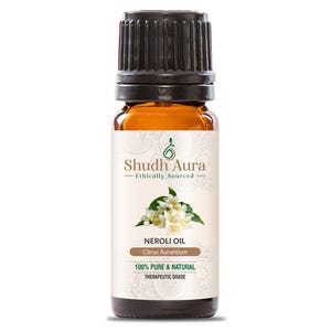 May include: A brown glass bottle with a black cap, labelled "Shudh Aura - Ethically Sourced" and "Neroli Oil - Citrus Aurantium - 100% Pure & Natural - Therapeutic Grade". The label also features a green leaf and a white flower.